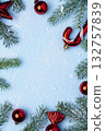 Christmas frame with red ornaments and snowy fir branches 132757839
