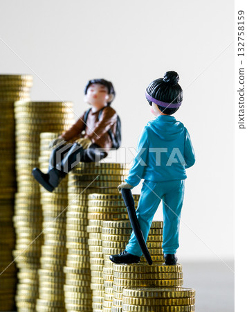Miniature people standing on stacks of golden coins representing wealth inequality and social gap 132758159