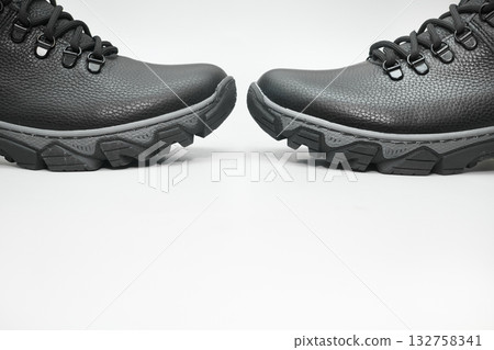 Pair of black winter leather warm boots with laces on white 132758341