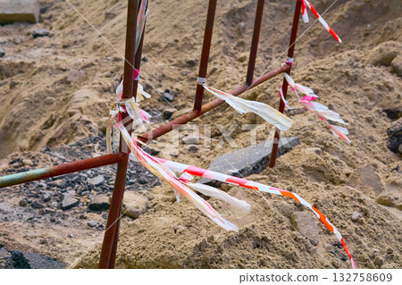 Construction.Metal fencing of a dug pit when laying plumbing pipes 132758609