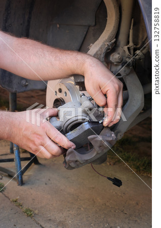 Car mechanic working on disc brakes Car mechanic working on disc brakes 132758819