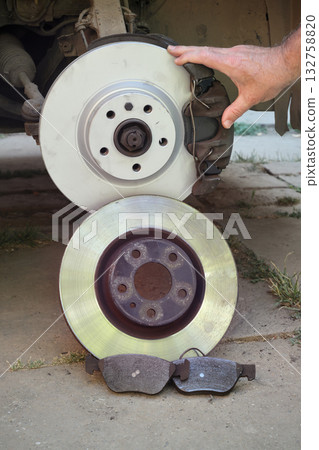Car mechanic working on disc brakes Car mechanic working on disc brakes 132758820