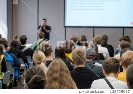 Speaker presenting at a conference to an attentive audience in a classroom setting Speaker presenting at a conference to an attentive audience in a classroom setting 132759087