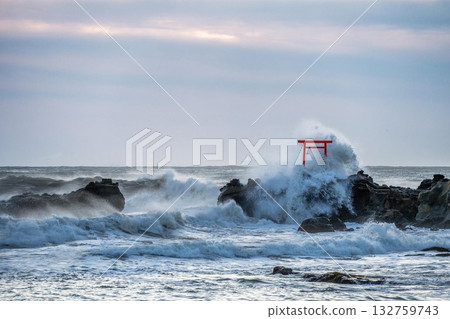 A torii gate towering over the stormy Pacific Ocean A torii gate towering over the stormy Pacific Ocean 132759743