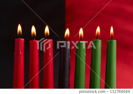 African American Kwanzaa holiday concept with traditional lit candles. Seven candles red, black and green African American Kwanzaa holiday concept with traditional lit candles. Seven candles red, black and green 132760089