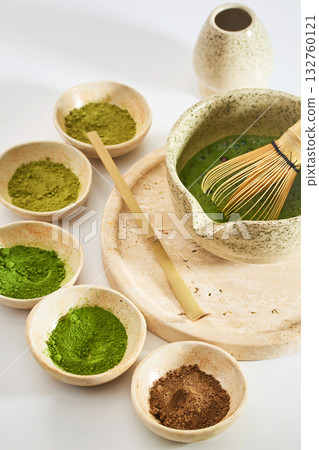 Matcha Ceremony Setup. Ceramic bowls with matcha powder and tools for a traditional tea ceremony Matcha Ceremony Setup. Ceramic bowls with matcha powder and tools for a traditional tea ceremony 132760121