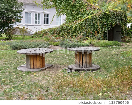 Two old wooden cable reels for construction site on green grass. 132760406