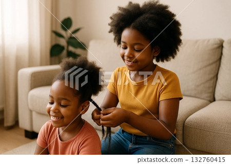 Mother Braiding Daughters Hair 132760415