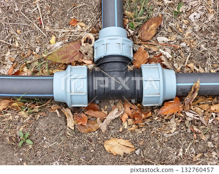Black and grey plastic pipes for irrigation in botanical garden. Black and grey plastic pipes for irrigation in botanical garden. 132760457