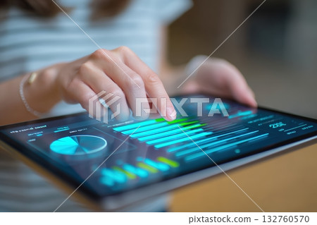 Woman Adjusting Sliders in Digital Budgeting App on Tablet 132760570