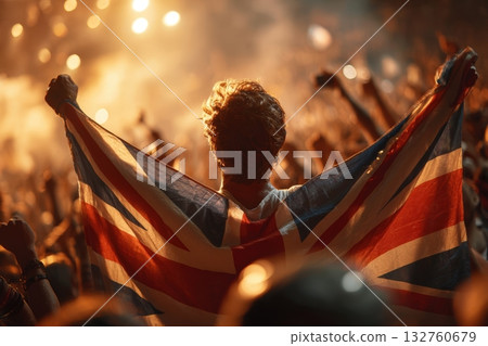 Passionate British Fan Cheering with Union Jack in Vibrant Crowd 132760679
