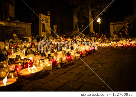 All Saints Day candles and lanterns at cemetery memorial, night background in Poland All Saints Day candles and lanterns at cemetery memorial, night background in Poland 132760953