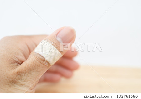 一隻手，拇指關節處纏著繃帶。 132761560