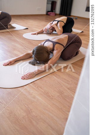 Peaceful yoga position for relaxation, gentle and relaxing yoga pose to ease tension and stress. Baby pose for lower back relaxation Peaceful yoga position for relaxation, gentle and relaxing yoga pose to ease tension and stress. Baby pose for lower back relaxation 132762095