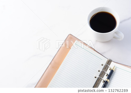 Image of doing desk work with coffee, a system notebook, and a ballpoint pen 132762289