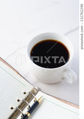 Image of doing desk work with coffee, a system notebook, and a ballpoint pen 132762290