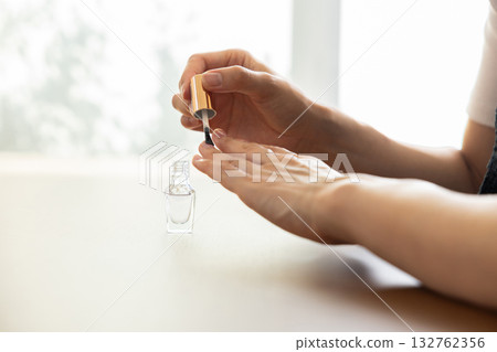 Woman's hands doing nail care 132762356