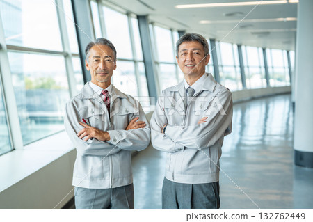 Senior man in work clothes with his arms crossed Senior man in work clothes with his arms crossed 132762449