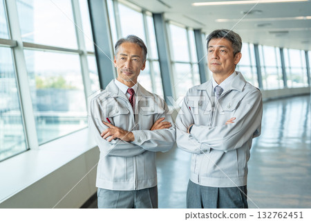 Senior man in work clothes with his arms crossed Senior man in work clothes with his arms crossed 132762451