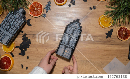 Gingerbread paper house handmade Storytelling creating craft Christmas holiday decoration. Tactile hand-on activity. Master class progress of creative me-made gifts. Seasonal domestic life micro 132763188