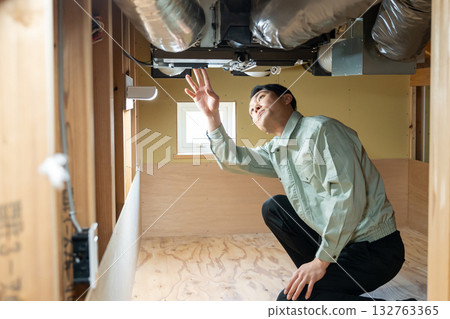Workers checking the air conditioner 132763365