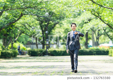Businessman walking in fresh green Businessman walking in fresh green 132763380