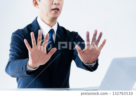 Man making a reluctant stop gesture 132763510