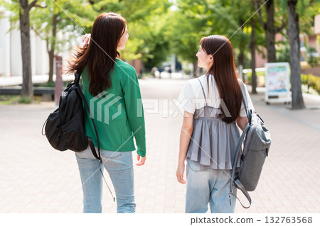 Female college student walking on university campus Female college student walking on university campus 132763568