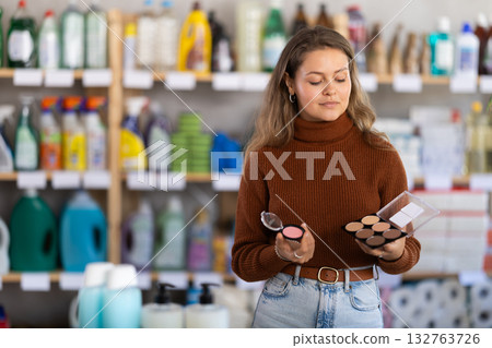 Young woman choosing cosmetics in retail store Young woman choosing cosmetics in retail store 132763726