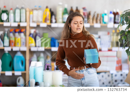 Young woman chooses feminine pads in store 132763734