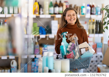Young woman chooses household chemicals in store 132763742