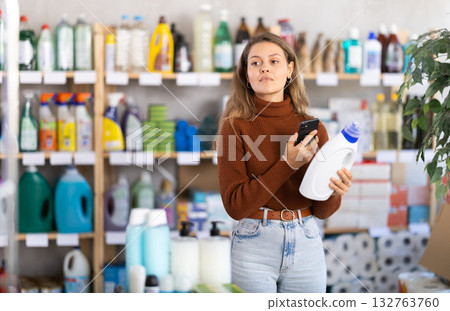 Young woman scanning qr code for detergent Young woman scanning qr code for detergent 132763760