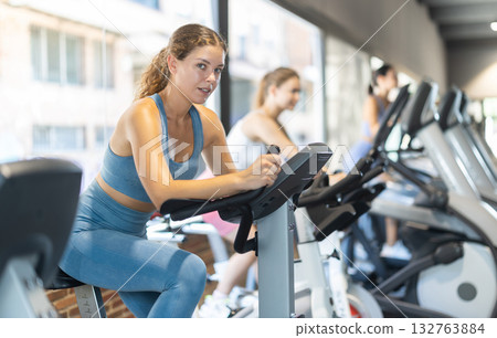 Woman exercising on an exercise bike in the gym 132763884