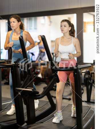 Woman exercising on a treadmill in the gym Woman exercising on a treadmill in the gym 132763922