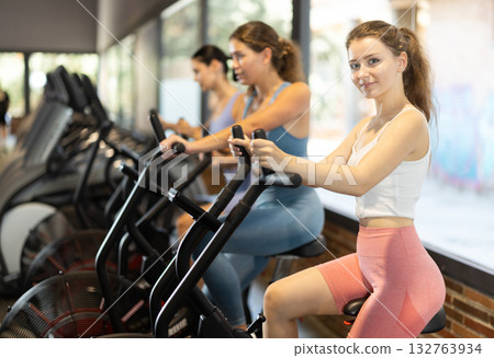 Woman on an airbike in the gym 132763934