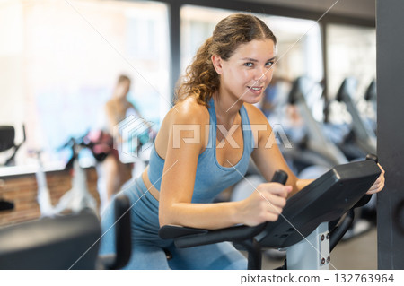 Woman exercising on an exercise bike in the gym 132763964