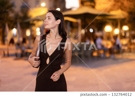 Young woman walking through urban street in Barcelona Young woman walking through urban street in Barcelona 132764012
