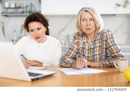 Old and middle-aged women joining distant education using laptop Old and middle-aged women joining distant education using laptop 132764097
