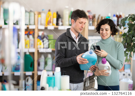 Married couple scanning detergent on mobile 132764116