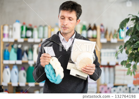 Middle-aged man choosing body washcloth in department store 132764198