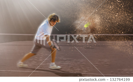 Man playing tennis in court 132764199