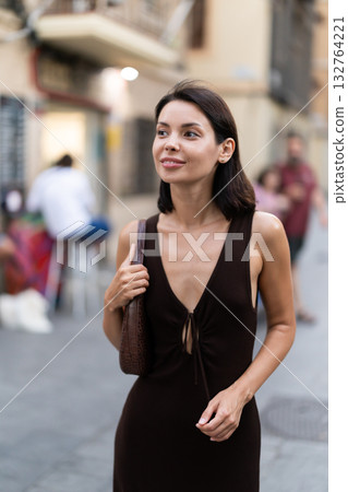 Young woman walks along narrow street in old Barcelona 132764221