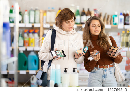 Mother and her adult daughter choose cosmetics together in supermarket Mother and her adult daughter choose cosmetics together in supermarket 132764243