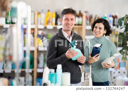 Husband and wife choose a spray for surfaces 132764247