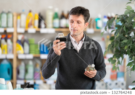 Middle-aged man choosing perfume at department store 132764248