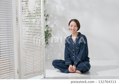 Woman relaxing in pajamas Woman relaxing in pajamas 132764313