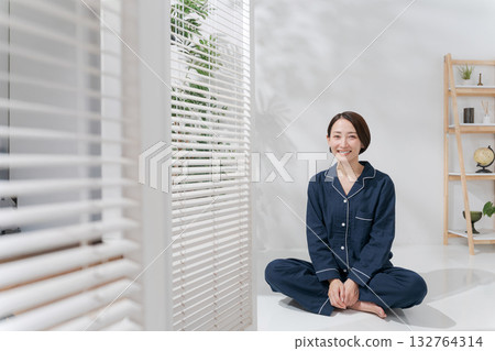 Woman relaxing in pajamas Woman relaxing in pajamas 132764314