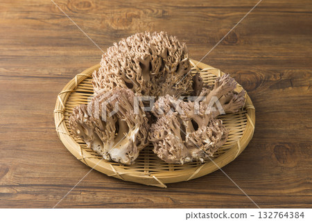 Broom mushrooms in a colander 132764384