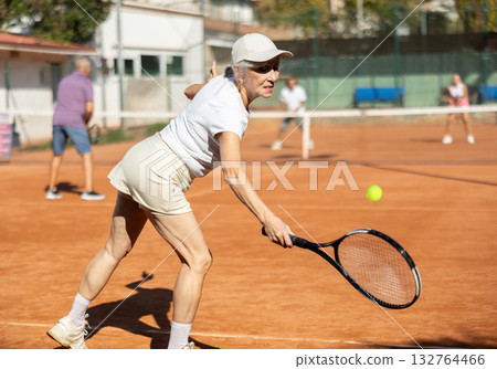 Elderly couple playing tennis together on summer court 132764466
