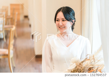 Wedding hall, dried flowers at the reception hall, bride in a dress holding a swag, bride 132764537